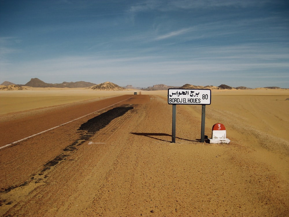 a road sign in the middle of a desert