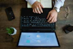 A professional entrepreneur working on a business plan with digital tools on a sleek desk.