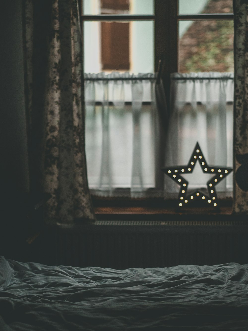 a star is lit up in front of a window