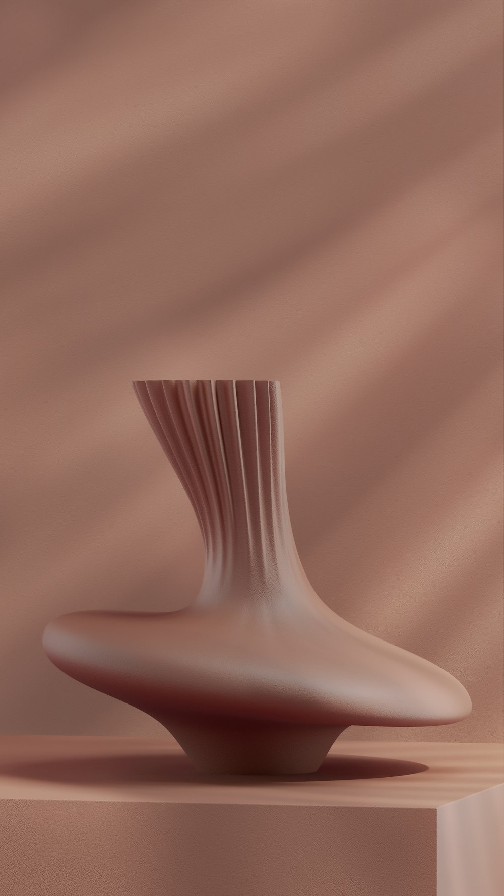 a white vase sitting on top of a wooden table