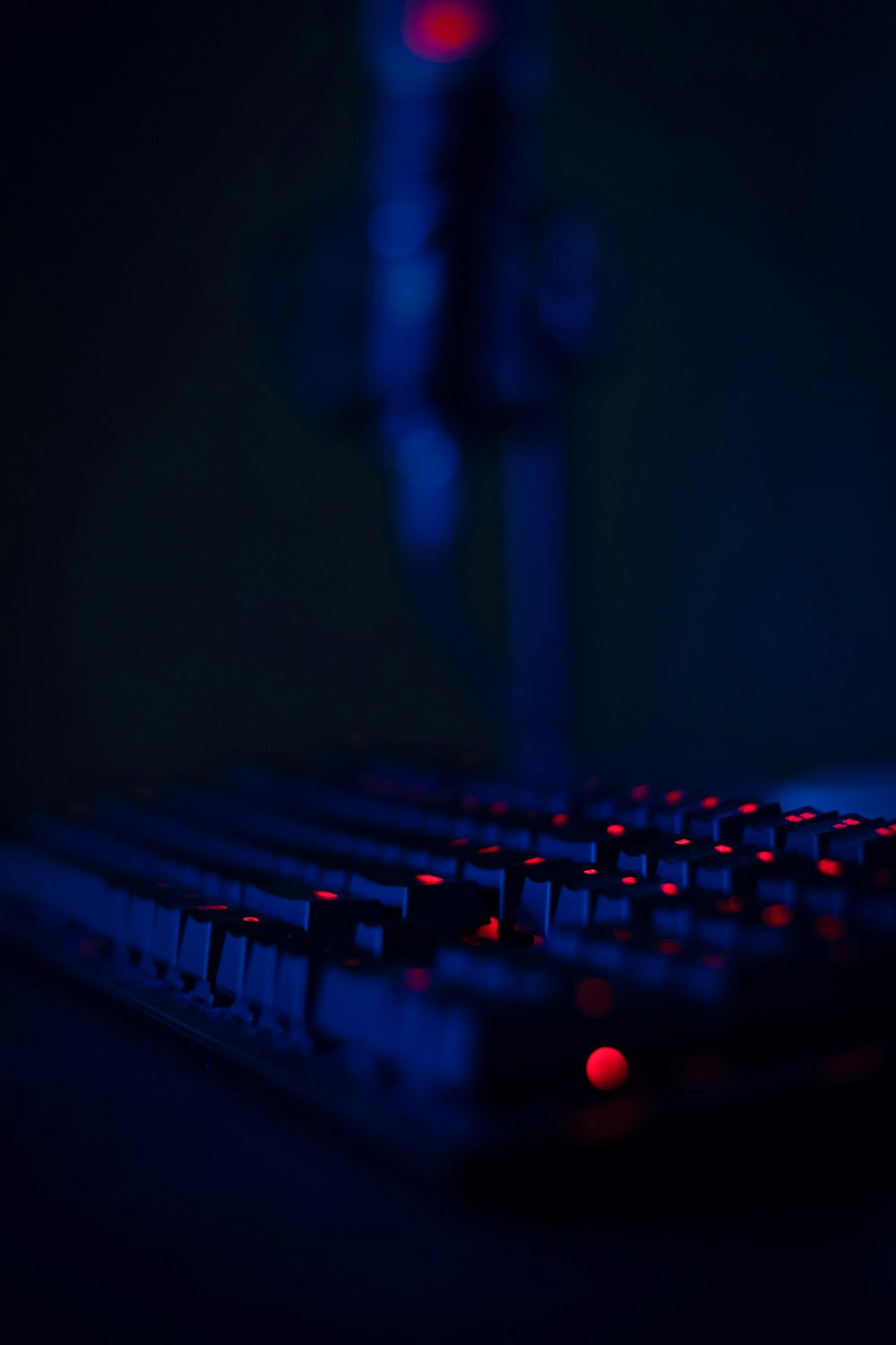 a close up of a keyboard with a red light on it