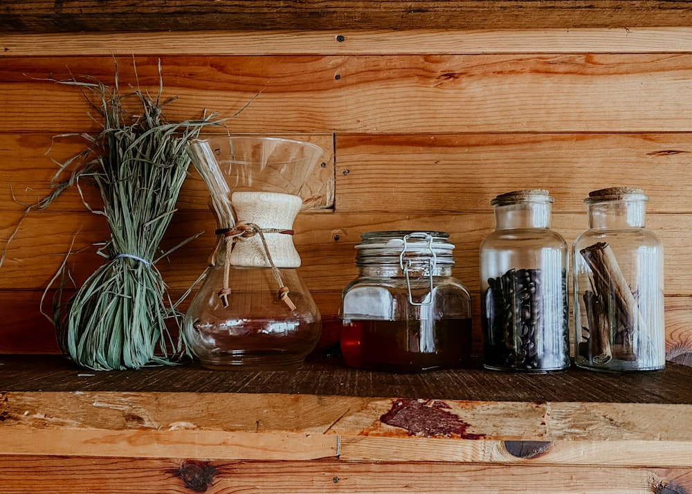 a shelf filled with bottles and jars filled with liquid