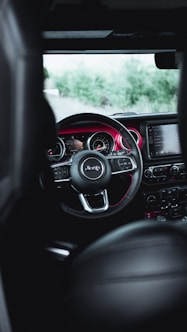 the interior of a car with a steering wheel and dashboard