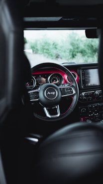 the interior of a car with a steering wheel and dashboard