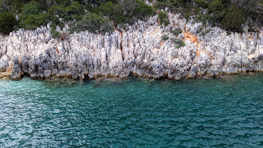 a rock formation in the middle of a body of water