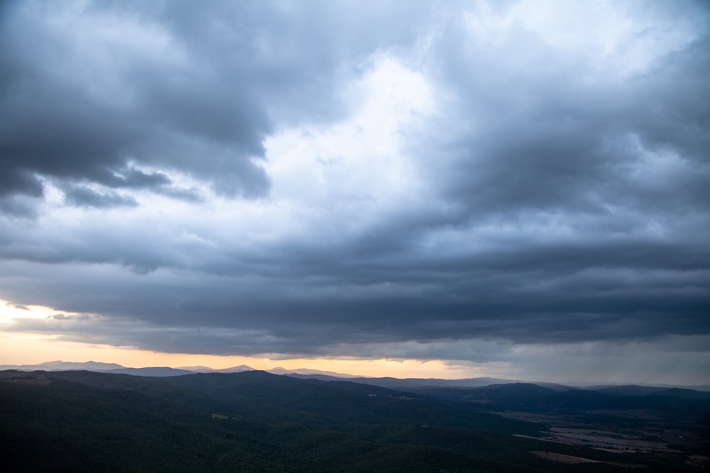 a view of a cloudy sky over a mountain range