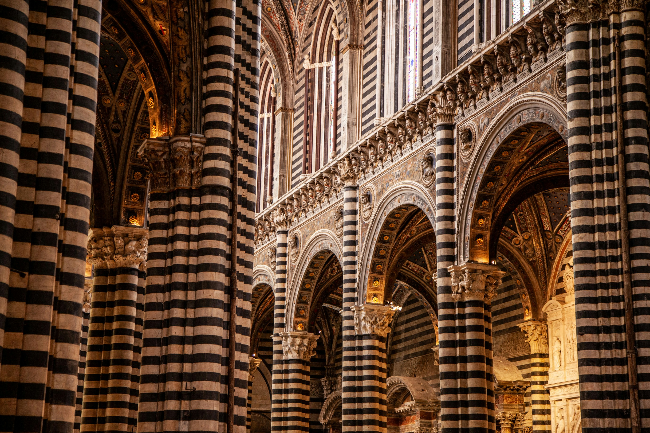 the interior of a cathedral with columns and arches