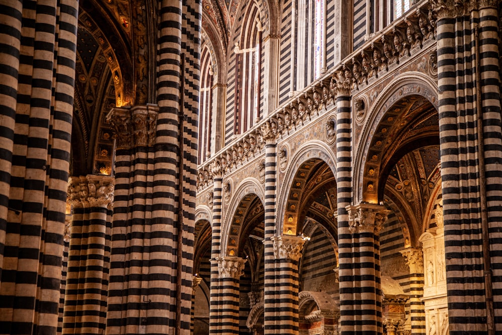 the interior of a cathedral with columns and arches