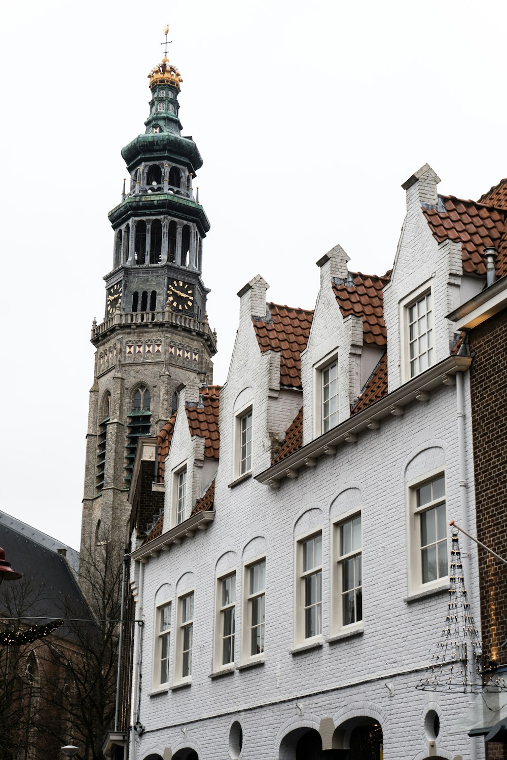 a tall white building with a clock tower in the background