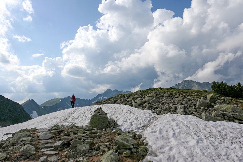 a person standing on top of a snow covered mountain