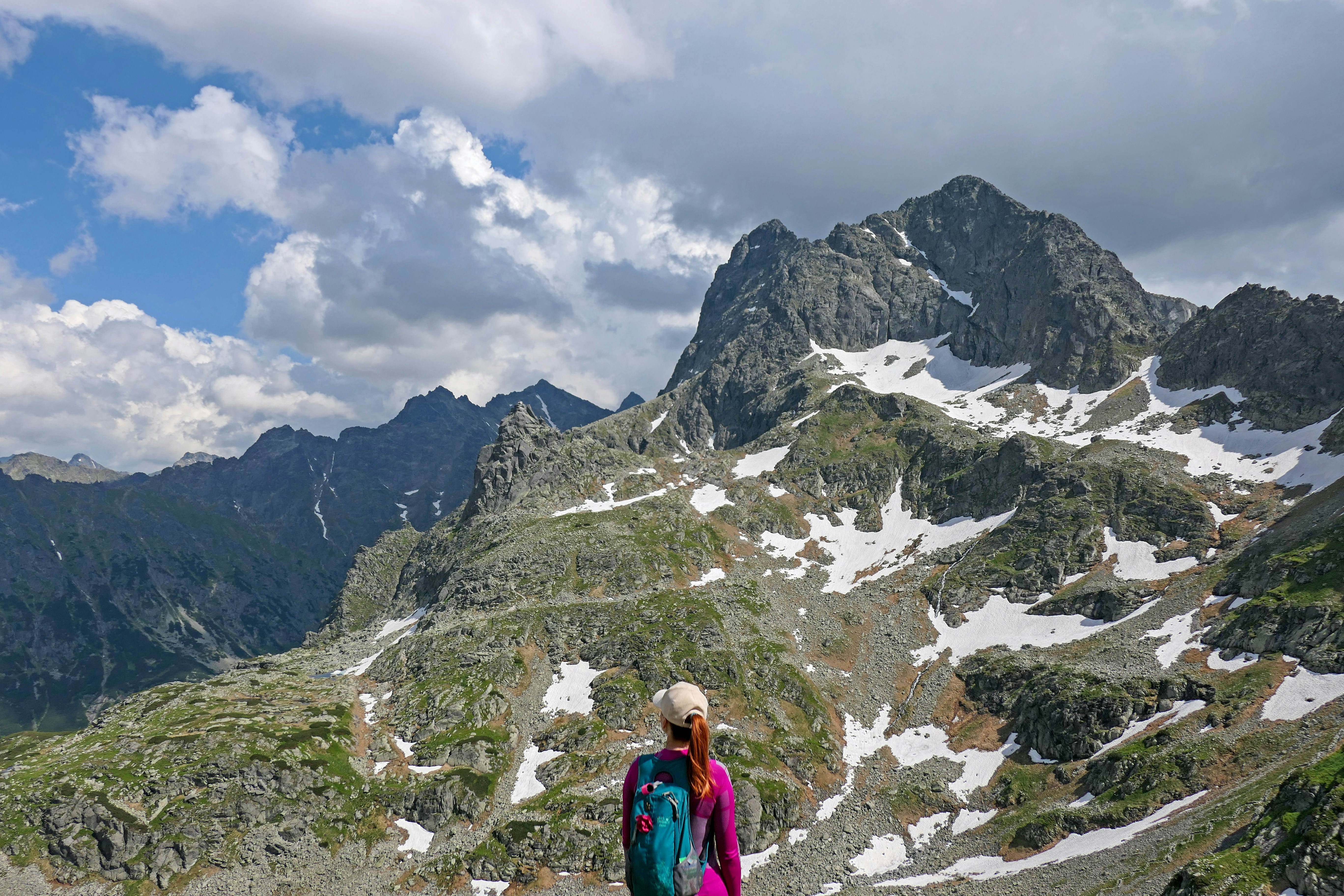 a woman standing on top of a snow covered mountain