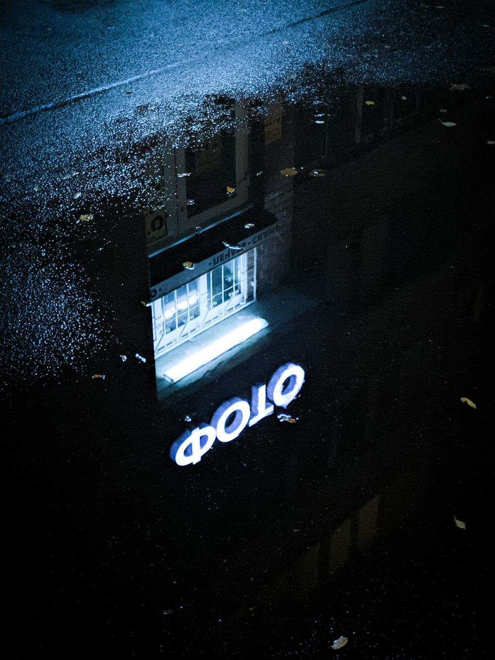 a building with a neon sign on the side of it