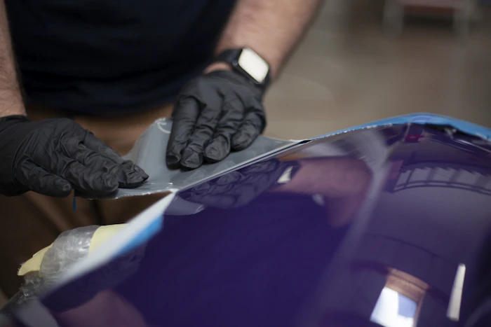 Hand applying detail product to panel