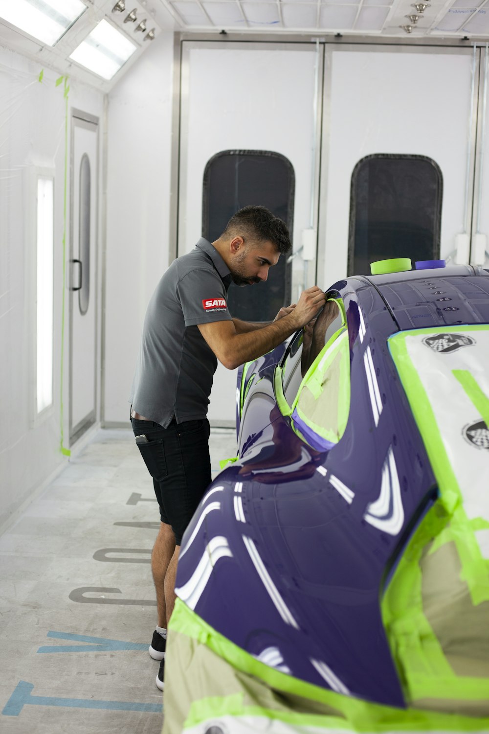 a man working on a car in a garage