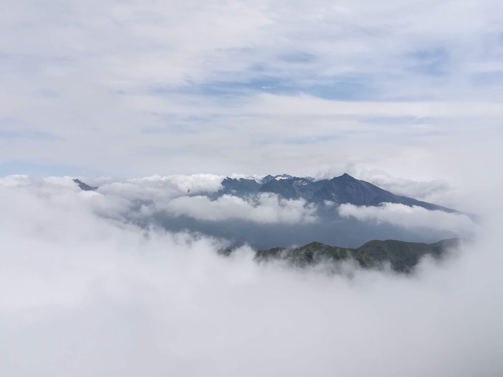 a view of a mountain covered in clouds