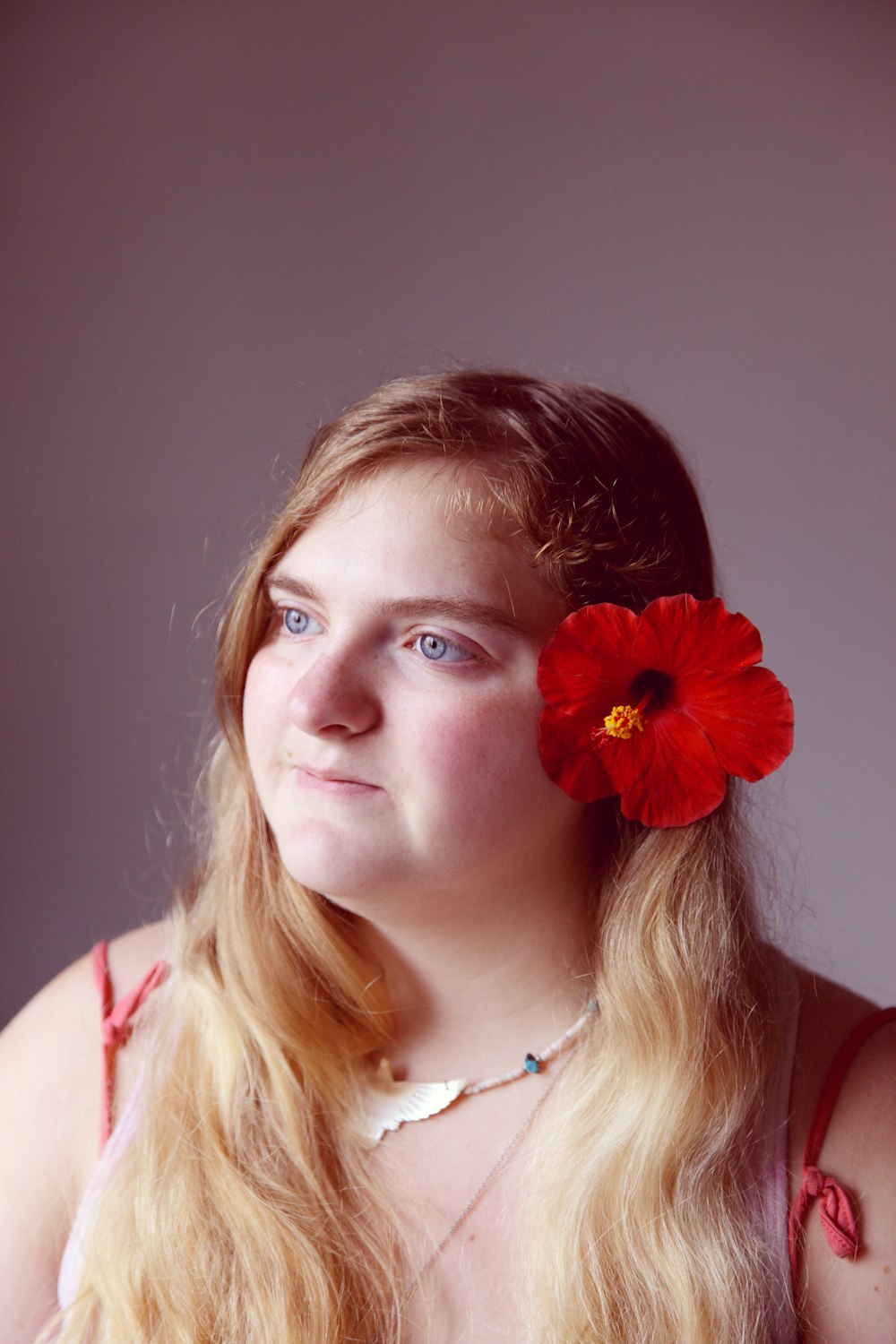 a woman with a flower in her hair