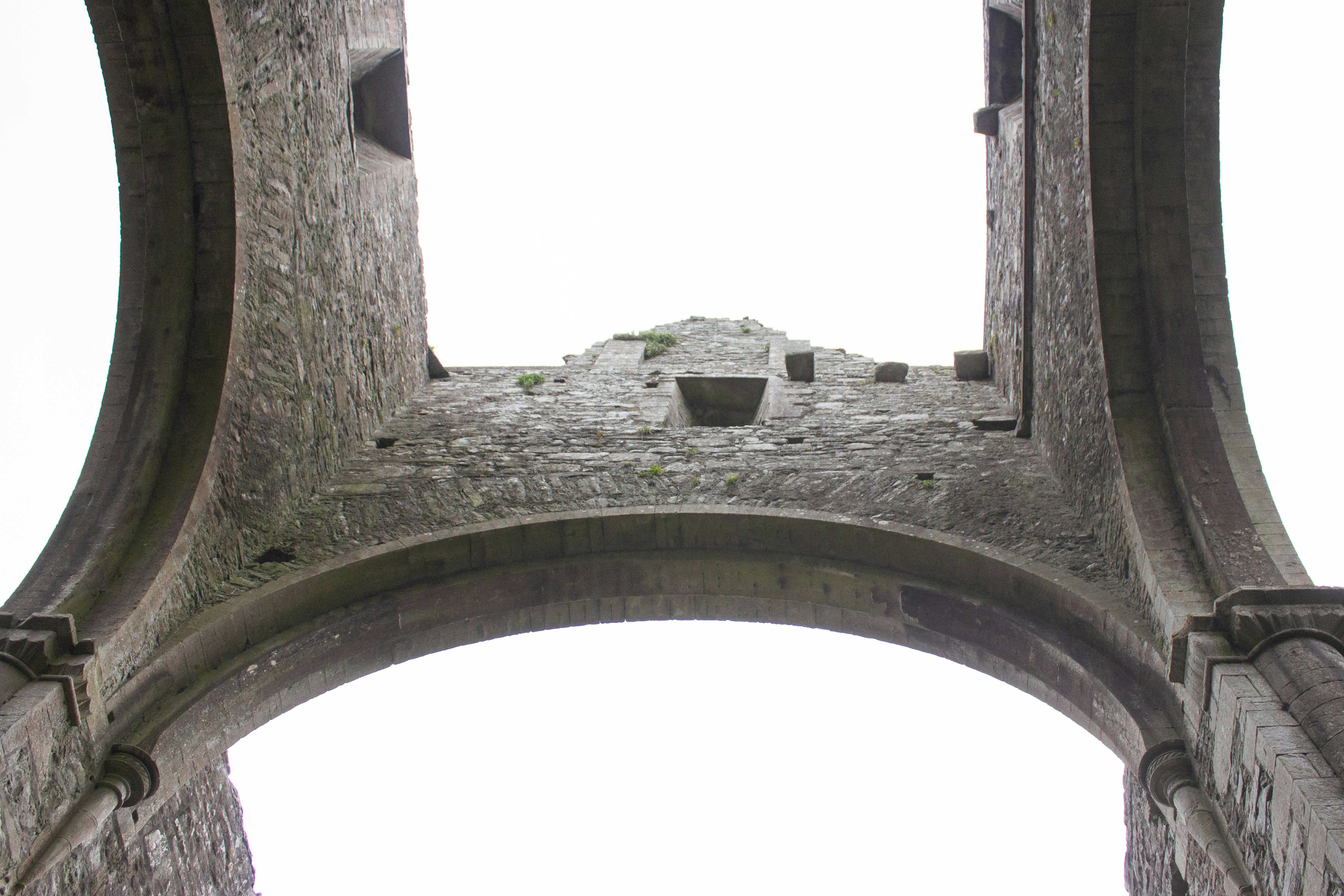 a stone structure with a clock on the top of it, The Boyle Abbey in Boyle, Ireland.