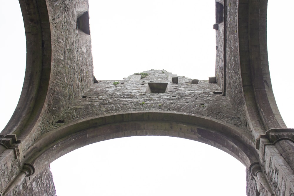 a stone structure with a clock on the top of it