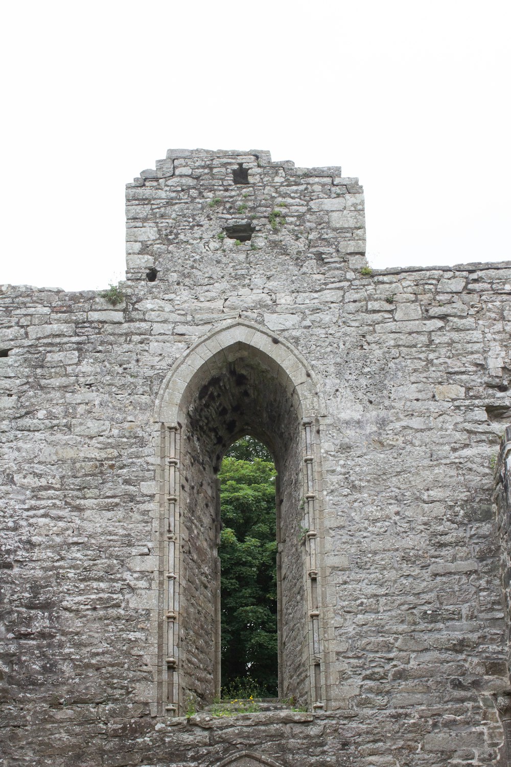 an old stone building with a window in it