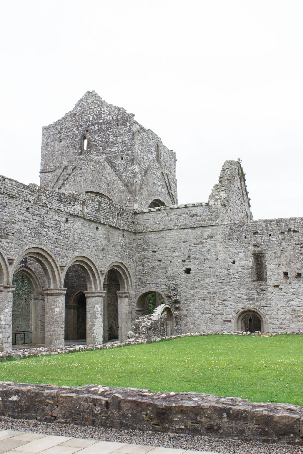 a stone building with a green lawn in front of it