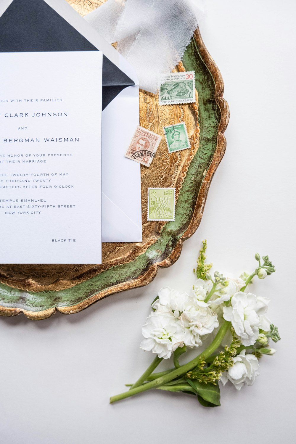 a close up of a wedding stationery on a plate