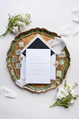 Elegant desk with a vintage lamp and wedding invitation suite laid out.