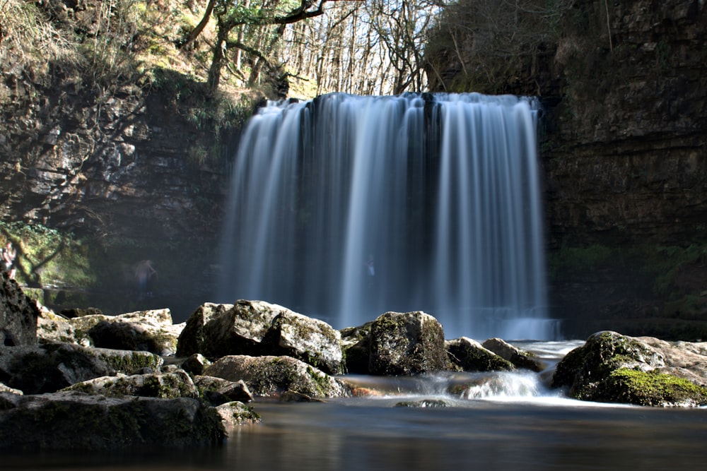 a large waterfall with water cascading over rocks