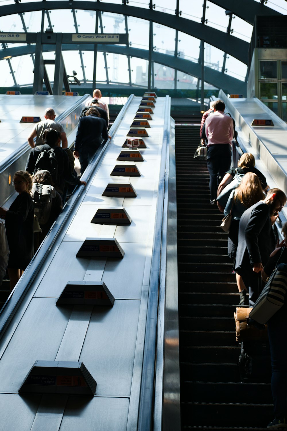 a group of people riding down an escalator