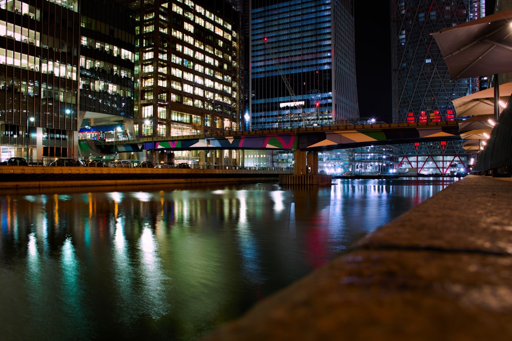 a city at night with lights reflecting in the water