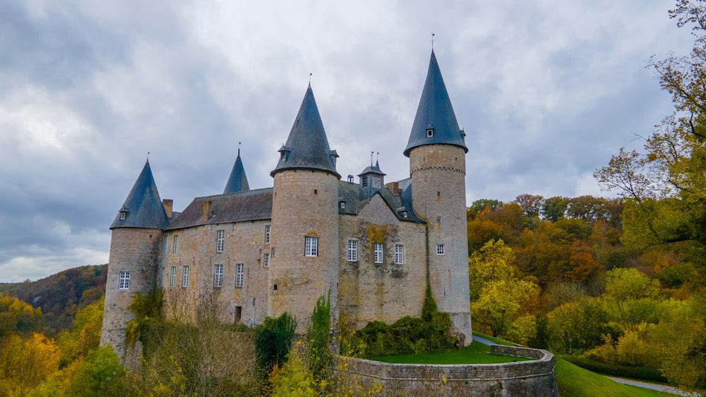 an old castle with towers and turrets surrounded by trees