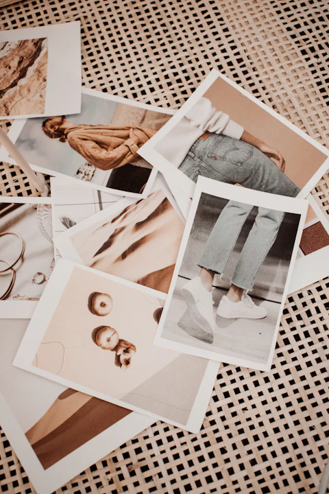 A spread of photographs and printed images scattered across a table for visual comparison