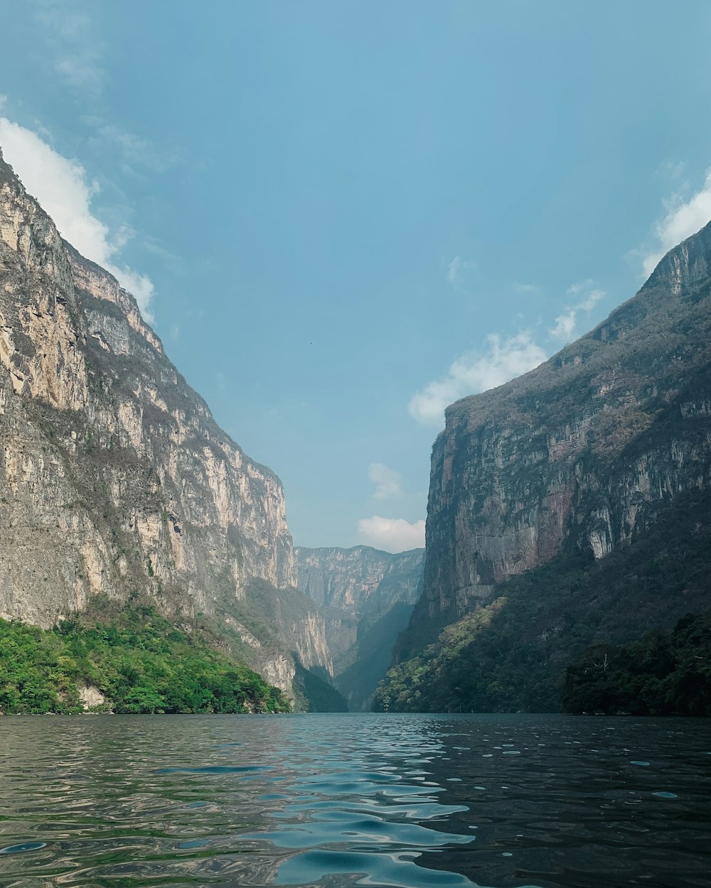 a body of water with mountains in the background