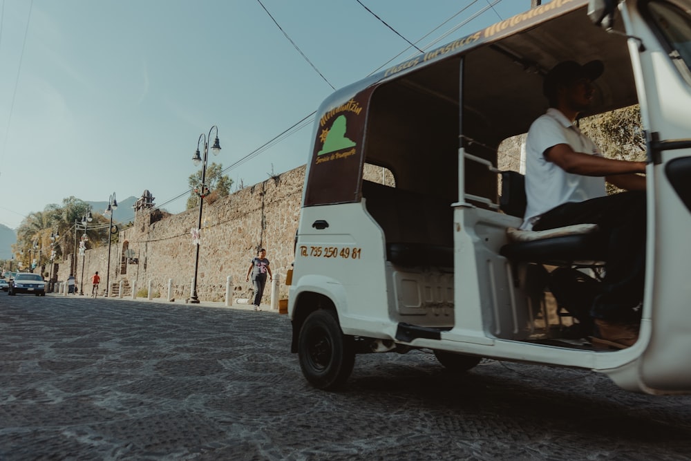 a man sitting in the back of a white bus