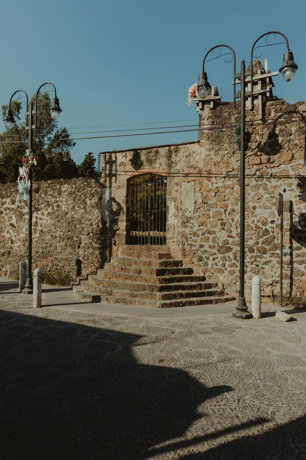 a stone building with a gate and stairs