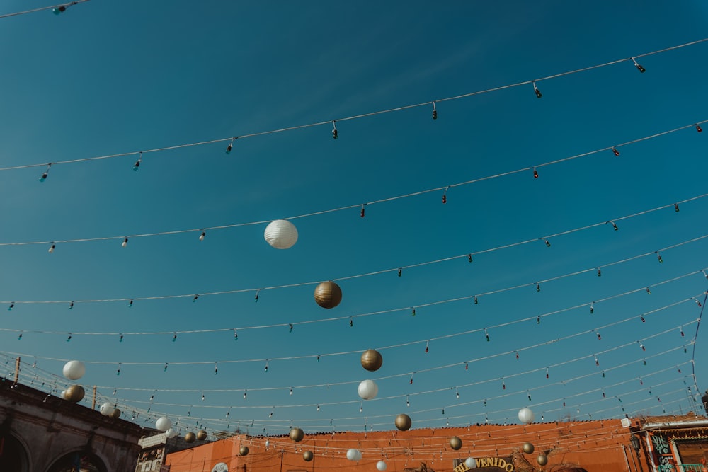 a bunch of white balls hanging from a wire