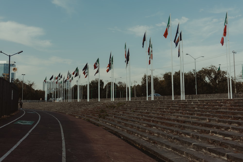 a bunch of flags that are next to some steps