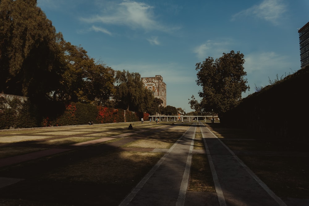 an empty road with a building in the background