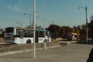 Rumbofiel transport vehicles lined up ready for daily routes under a clear sky