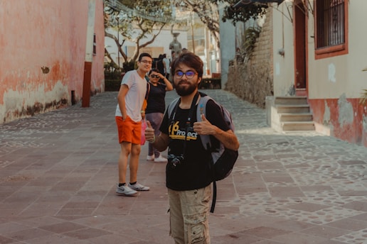 a man with a backpack is standing in the street