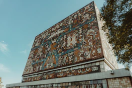 Colorful mural showcasing themes of creativity and design at a university venue in Nayarit.