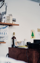 A modern kitchen corner neatly organized with adhesive hooks and storage containers.