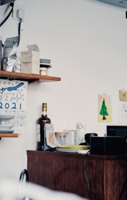Compact kitchen corner with stylish shelves and colorful organized containers.