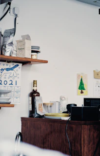 Cozy kitchen corner featuring colorful gadgets and small electro cleaning products arranged neatly on wooden shelves