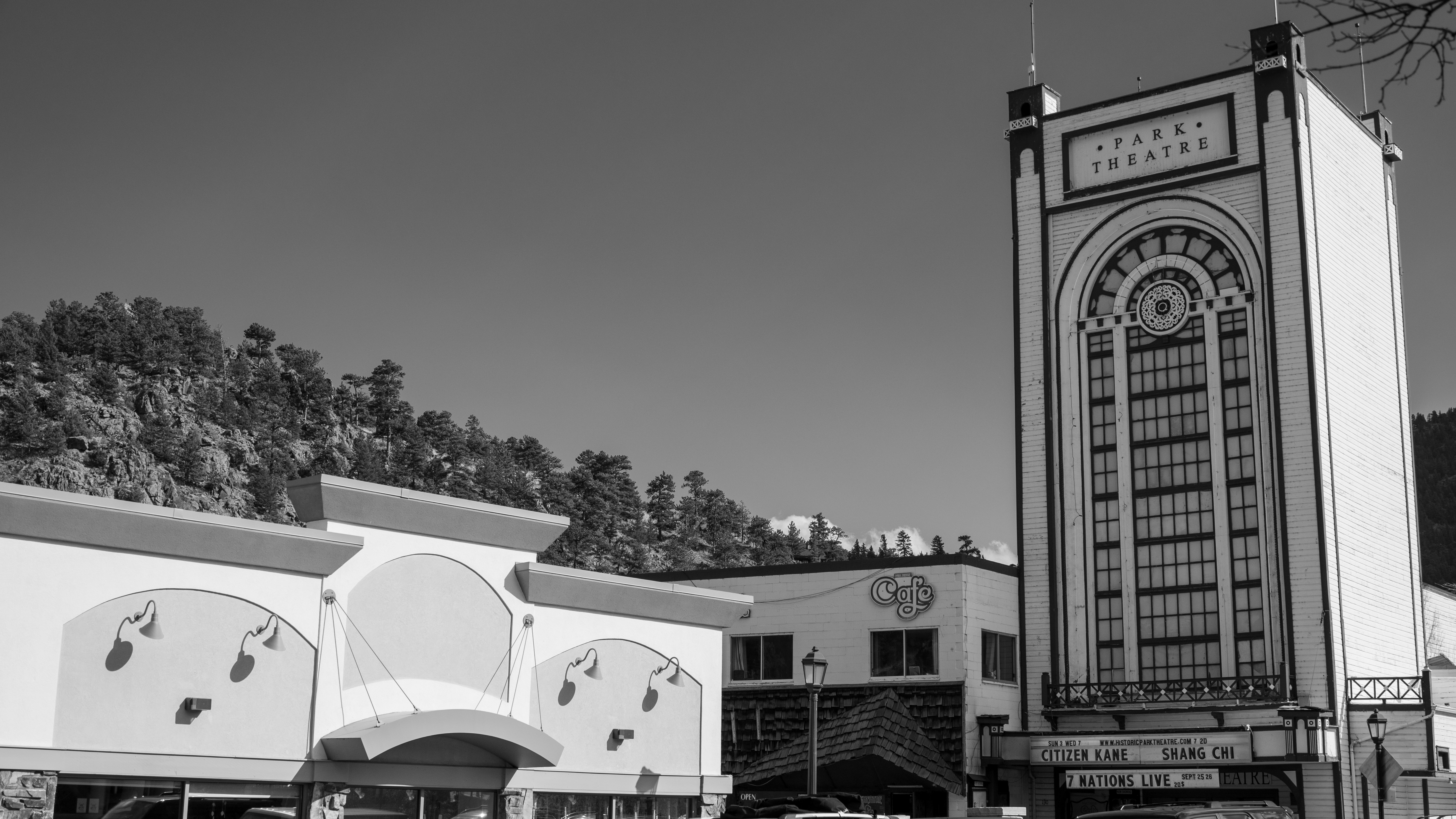 a black and white photo of a building and a clock tower