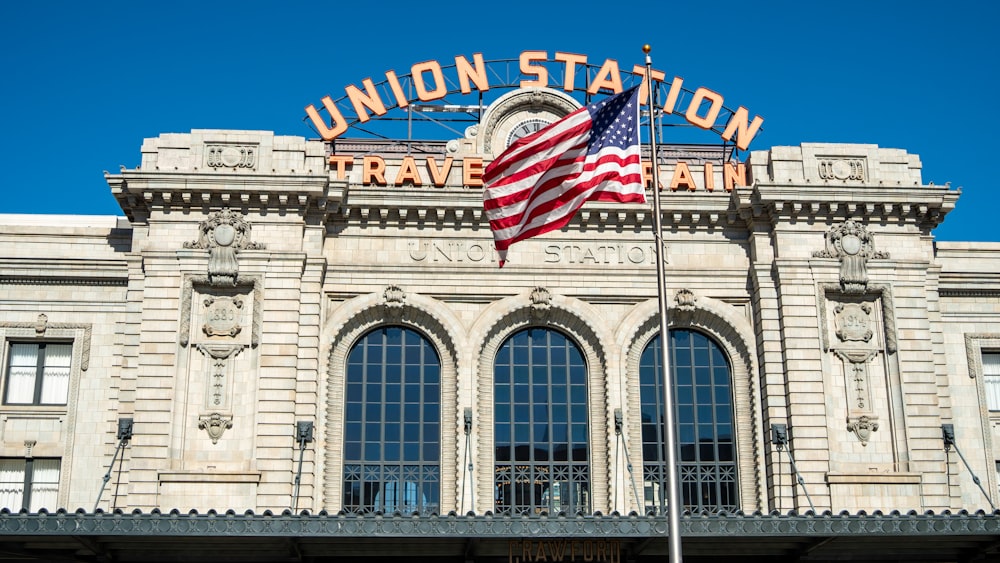 a large building with a flag flying in front of it