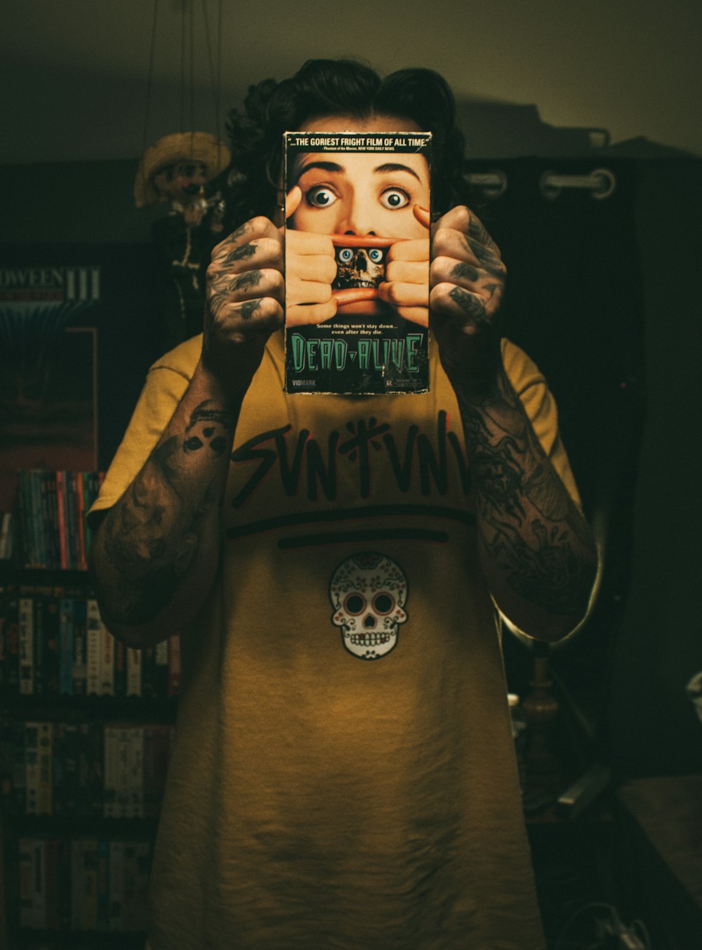 a man holding up a book in front of his face