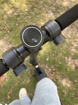 Close-up of a scooter's handlebar featuring a digital display glowing in green neon.