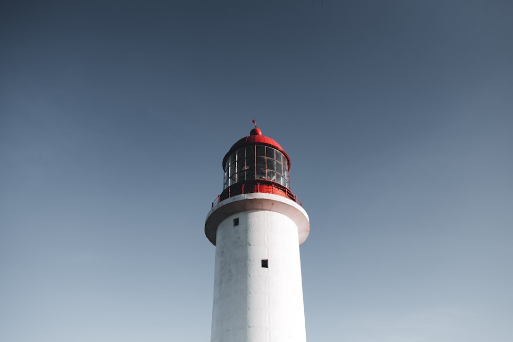 a white and red lighthouse on a clear day