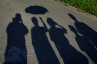 A safety umbrella casting a protective shadow over a group of diverse people.