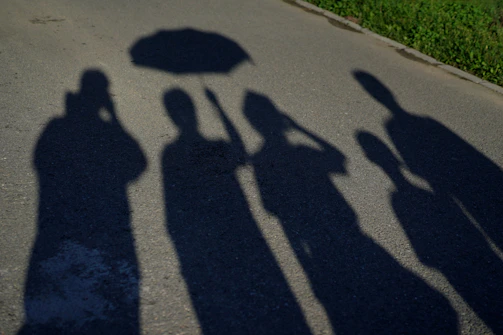 A safety umbrella casting a protective shadow over a group of diverse people.